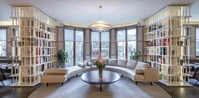 Luxury hotel lobby lounge with circular seating for VIP meetings and corporate networking events.
