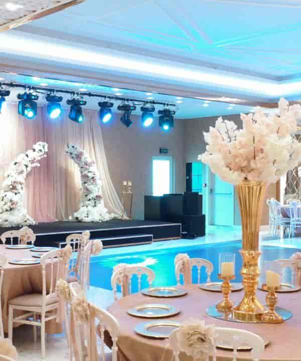 Mint Kayaroyal ballroom with floral stage, perfect for elegant wedding and gala events.