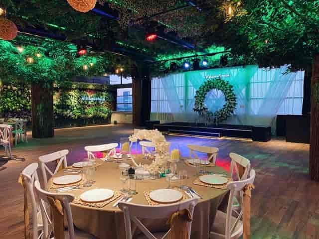 Enchanted forest garden event space with stage lighting for gala and corporate dinner.