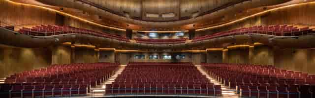 AKM tiered auditorium with wood paneling for keynote presentations and awards ceremonies.