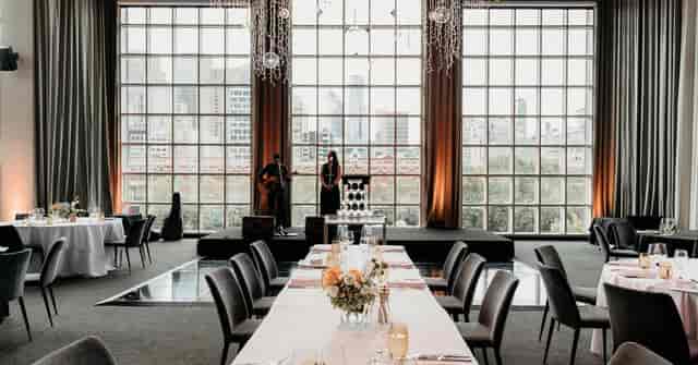 Main Event Space with industrial windows for corporate dinners and elegant private events.