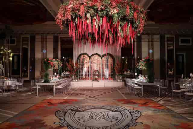 Luxury ballroom event setup with floral chandelier for upscale wedding and gala venue.