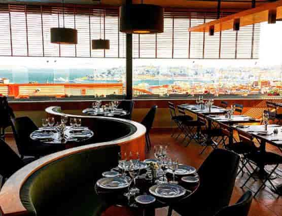 Upscale Ouzo Roof Restaurant bar with banquet seating for corporate dinners and cocktail events.