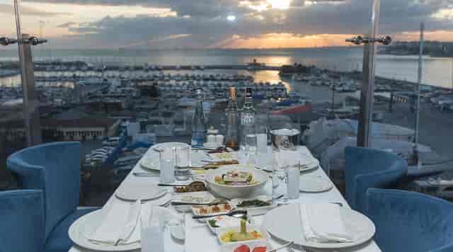 VIP dinner at Ouzo Roof bar, marina rooftop view, luxury private event venue.