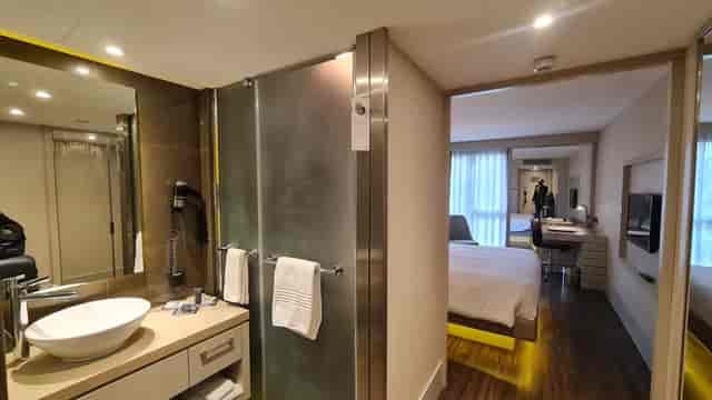 AC Hotel Istanbul Macka compact hotel room with open vanity for business travel events.