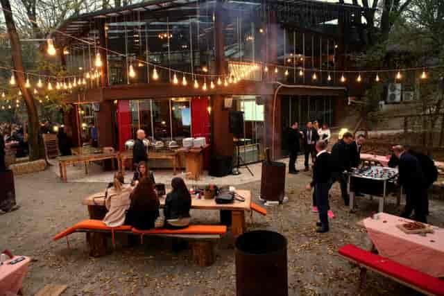Izoletta Glass Salon outdoor corporate mixer with bistro lighting for professional networking events.