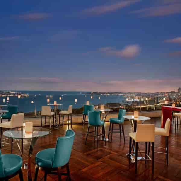 Summit Bar & Terrace rooftop banquet hall with sunset backdrop for corporate networking events.