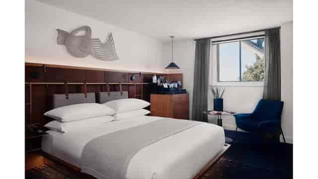 Luxury Bridge Marquee hotel room with modern workspace for VIP business travel and events.