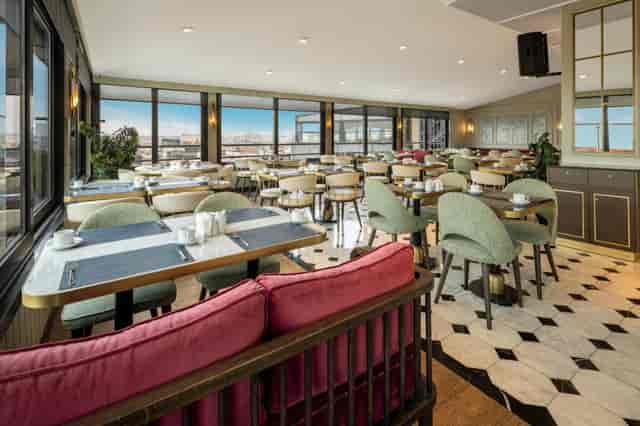 Modern Zurich Hotel restaurant with panoramic views, ideal for networking and corporate events.