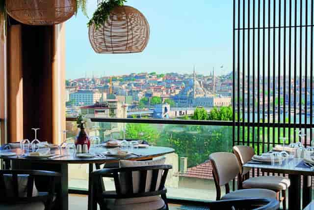 Upscale hotel cafeteria with Galata skyline view for corporate dinners and incentive receptions.