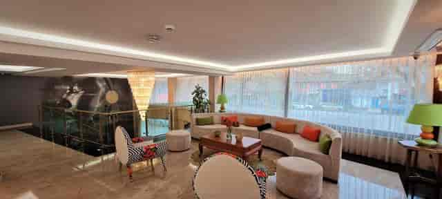Modern corporate networking suite at Tuzla Garden Hotel & Spa with bold accent furniture.