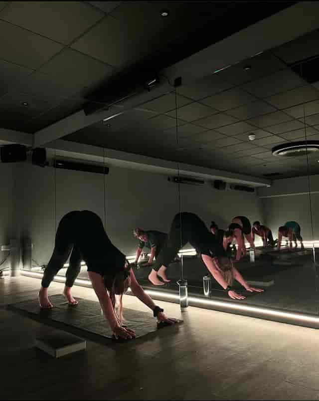Wellness breakout session in mirrored yoga studio for corporate fitness event.