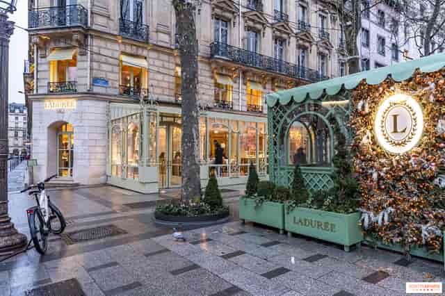 Luxury Parisian pop-up storefront with floral design for upscale event activations.