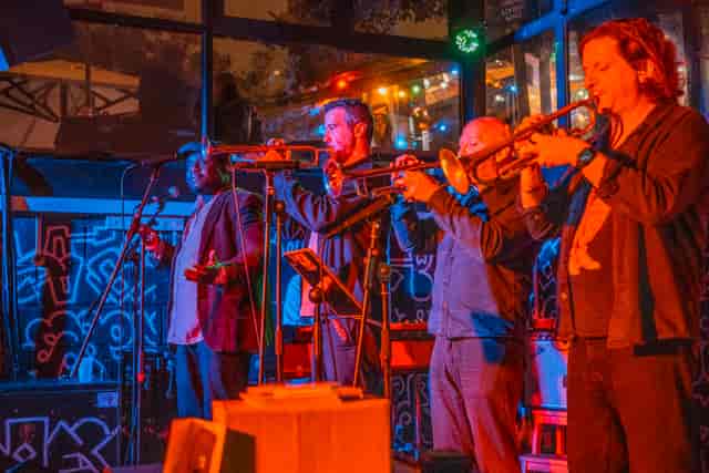 Live jazz band with ambient stage lighting at a Hackney Wick corporate event venue.