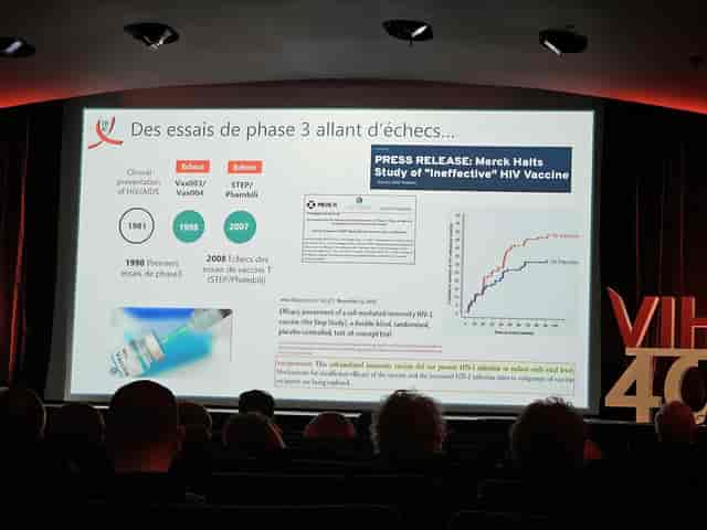 Scientific plenary presentation at Espace Saint-Martin with professional stage branding.