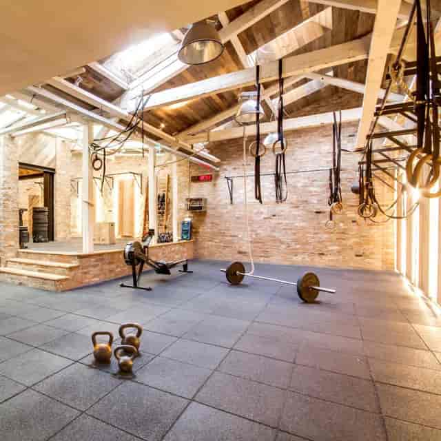 Rustic-industrial gym in Place de la Bastille for corporate wellness and team-building events.