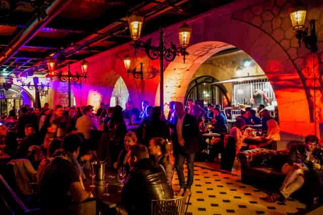 Maison Faust bar lounge with ambient lighting for networking reception event.