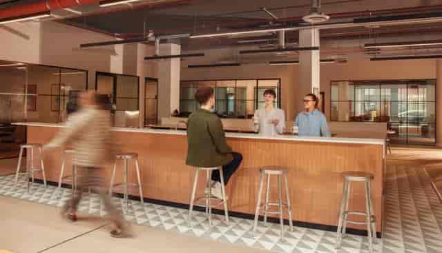 Modern Laundry Studios Meeting Room E with bar-height seating for corporate networking events.