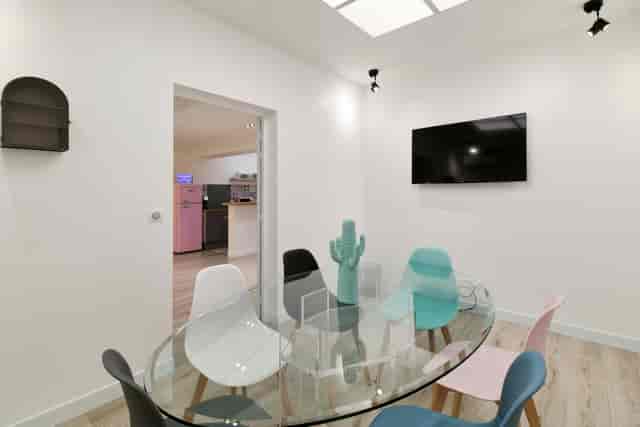 Small meeting room with glass table for collaborative breakout sessions and team huddles.