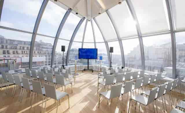 Minimalist rooftop theater at The Loft featuring a sun-drenched architectural dome for events.