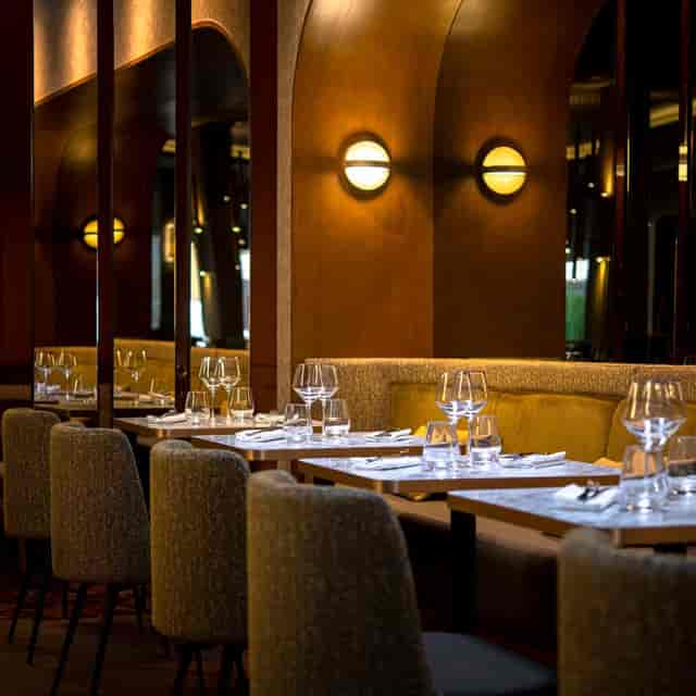 Upscale dining room at SPHERE with ambient lighting for executive lunches and networking dinners.