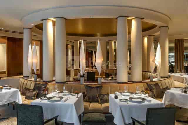 High-end circular banquet space with architectural pillars for corporate dinners and networking.