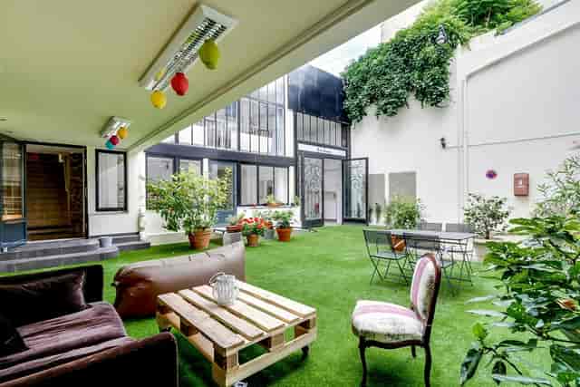 Outdoor breakout space with industrial decor, ideal for networking and team-building events.