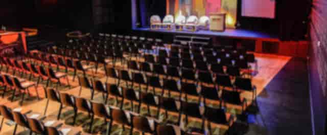 Pan Piper conference center: theater-style stage for corporate event or keynote presentation.