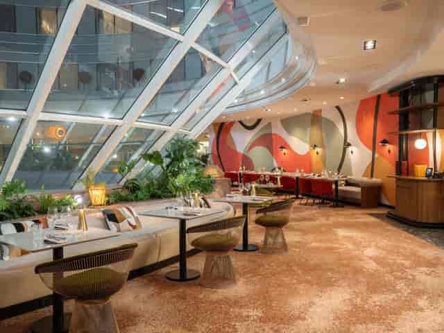 Muses Restaurant dining room with natural light for VIP networking and corporate event breakouts.
