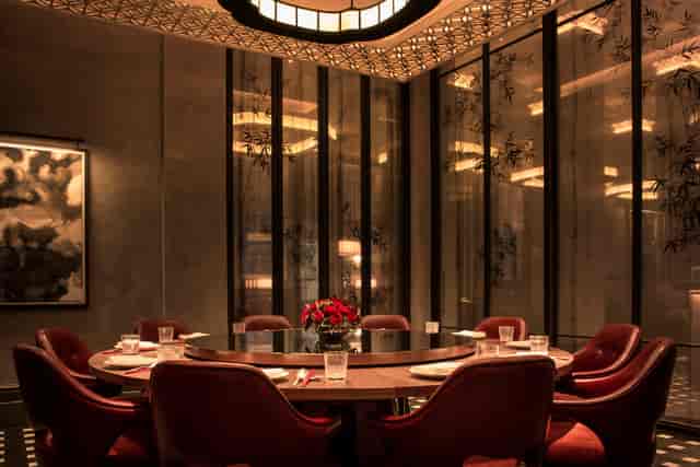 Sophisticated meeting space with round table for strategic planning at Mei Ume.
