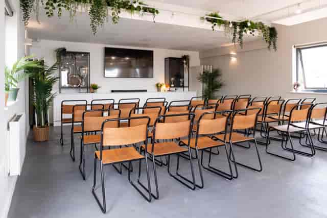 The Clubhouse Brighton: Modern theater-style workshop space with biophilic design.