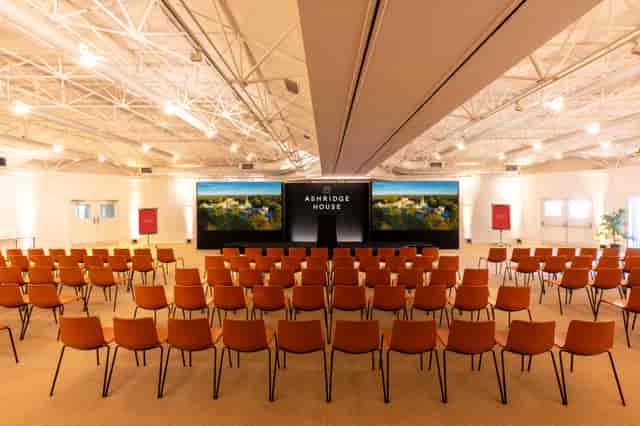 Fairhaven event space at Ashridge House with theater seating and LED screen for corporate conferences.