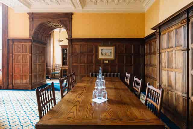 Sitting Room at Ashridge House: elegant meeting space with wooden table for corporate events.