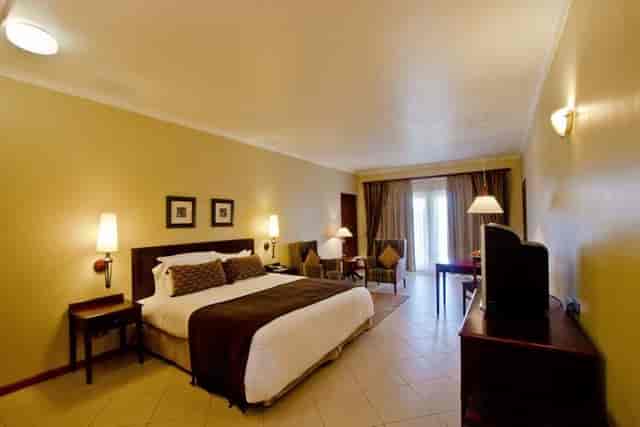 Hotel guest room with workspace at White Sands Resort for business conferences.