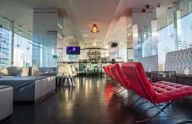 Upscale lounge at Restaurant 31A with red seating for business networking and corporate events.
