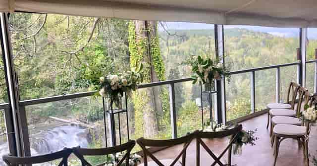 Hidden Terrace wedding venue at Salish Lodge with cross-back chairs and scenic outdoor backdrop.