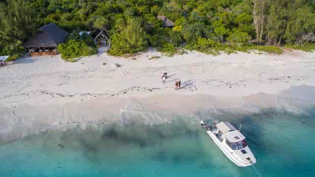 Executive retreat at andBeyond Mnemba Island lodge with private beachfront setting.