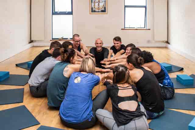 Yoga studio team-building session with circular layout for corporate wellness and group synergy.