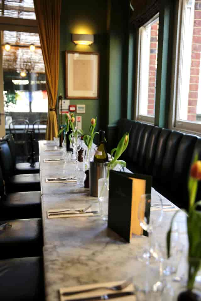 Black leather banquette dining at The Chamberlayne for corporate networking and private dinners.