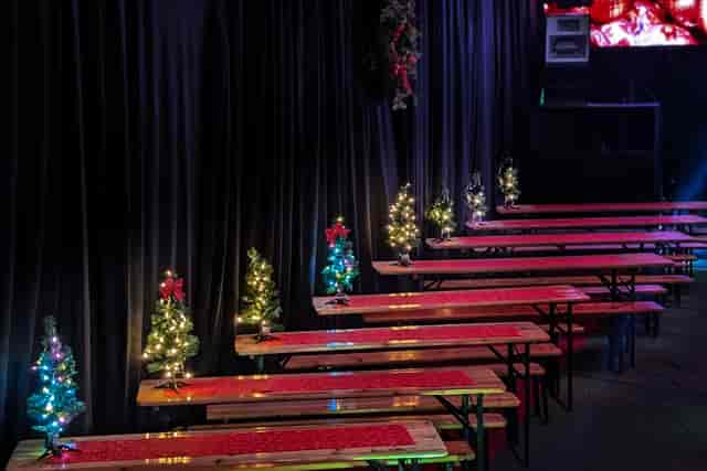UnderTheArches Fibre holiday event with tiered beer garden benches for festive corporate gatherings.
