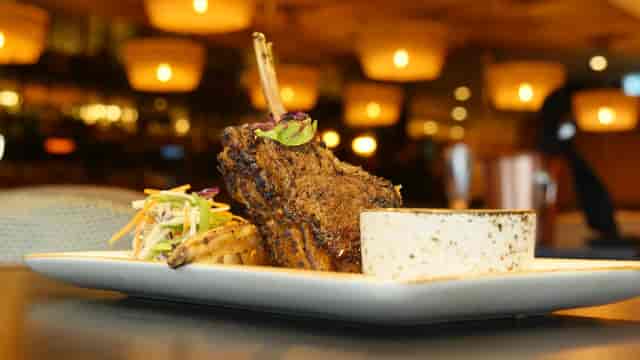 Gourmet seared lamb chop entrée for premium gala dinner or corporate reception catering.