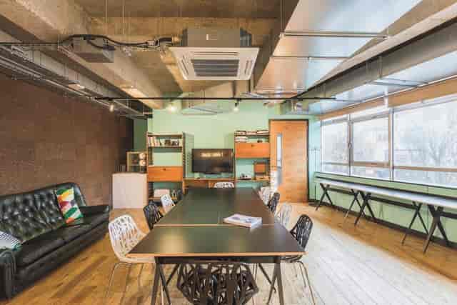 Industrial-chic meeting room with lounge seating for creative workshops and team huddles.