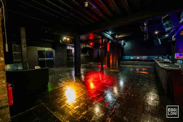 Industrial event space with dark floors for product launches and corporate social gatherings.