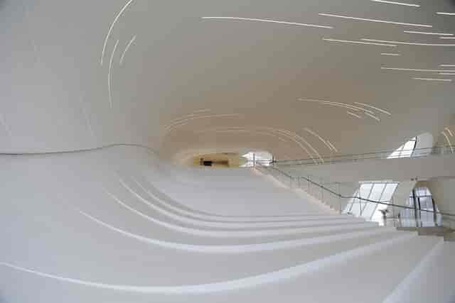 Heydar Aliyev Center atrium with curved architecture for corporate event or red-carpet venue.