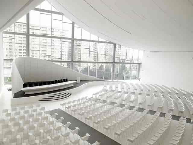 Heydar Aliyev Center exhibition hall with curved stage for corporate events and conferences.