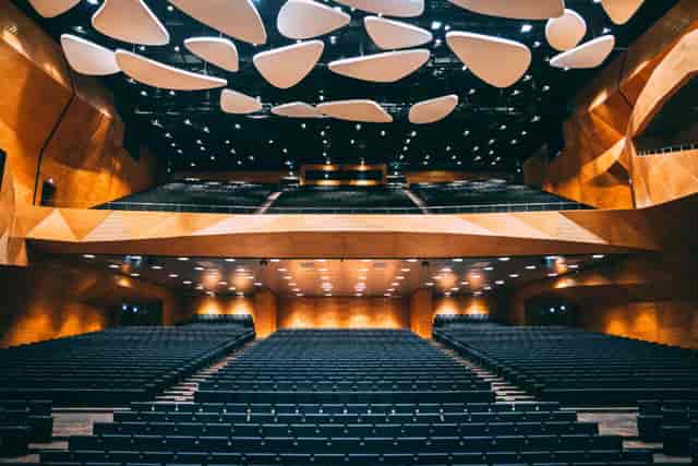 Modern auditorium with tiered seating, ideal for corporate keynote presentations and conferences.
