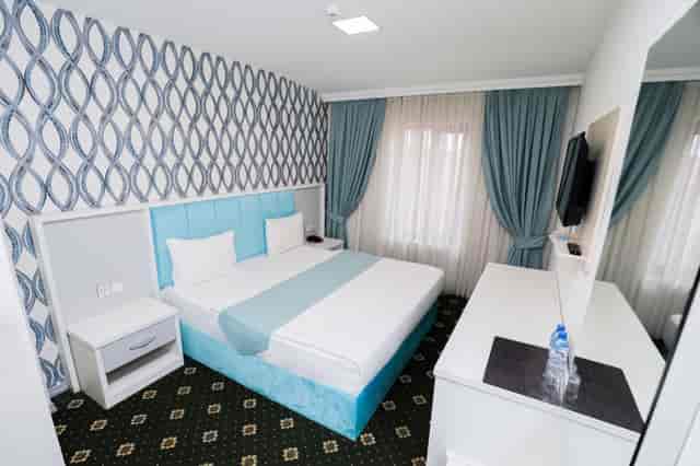 Corporate hotel room at Altus Hotel Baku, featuring functional design for business travel events.