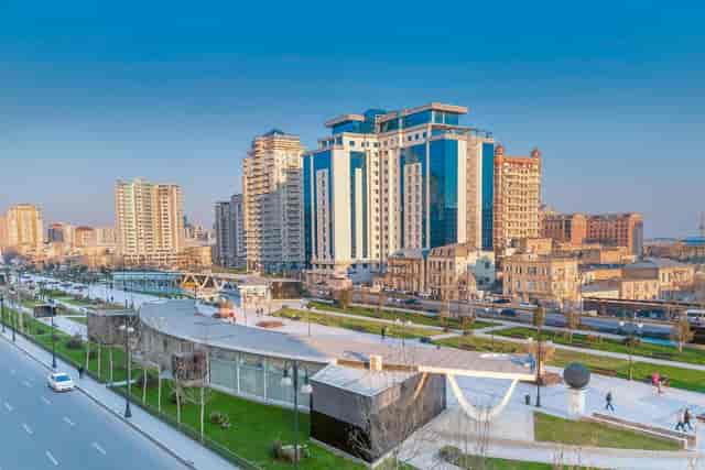 Modern business venue at Zumrud, Baku: glass architecture and green space for corporate events.