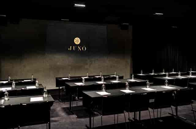 Sleek dark classroom setup at Juno Hotel for executive corporate board meetings.