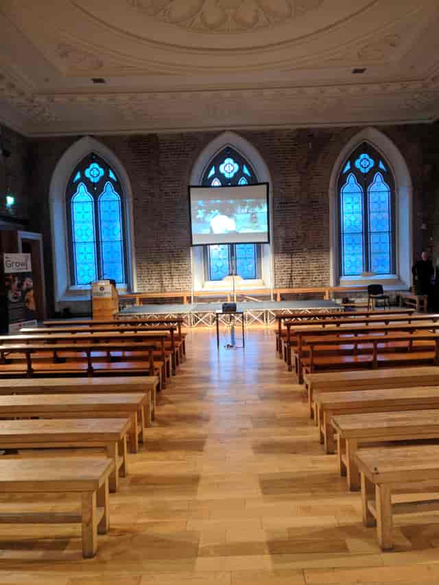 Historic Smock Alley Theatre banquet hall with bench seating for corporate events and presentations.